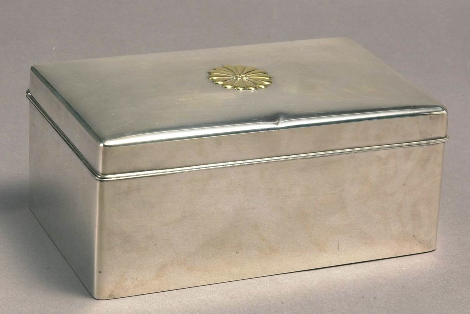 Silver tobacco box bearing the Japanese royal insignia.